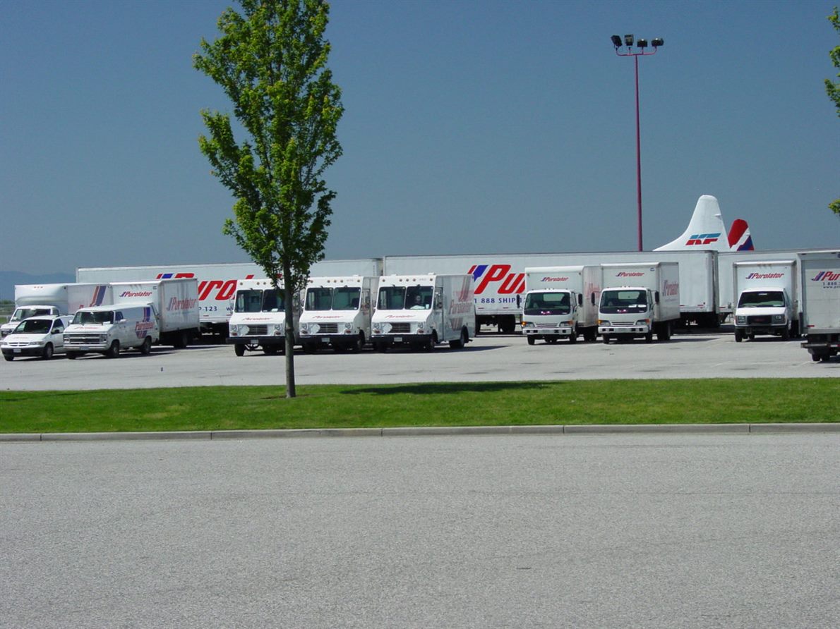 Rows of delivery vans and trucks in a fleet yard