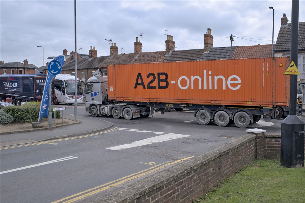 Articulated container lorry turning at a junction