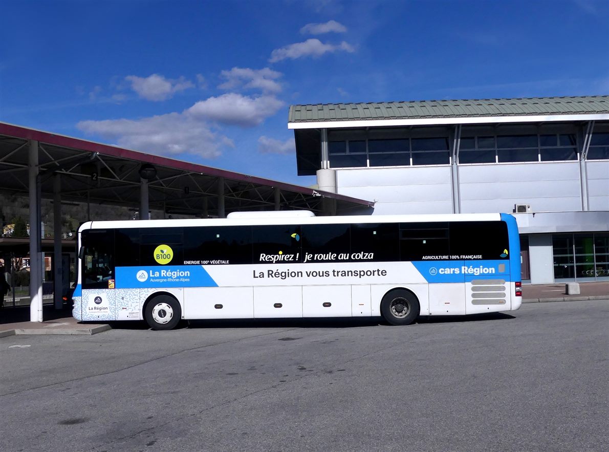 Twelve-meter intercity coach parked side-on at a bus station