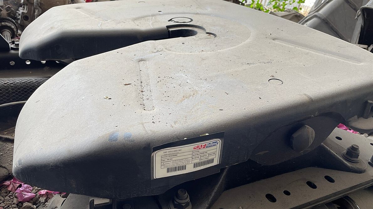 Close view of a Saf Holland fifth-wheel coupling plate, the horseshoe-shaped throat where the trailer kingpin locks in and pivots