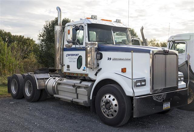 A white Western Star tractor unit seen from the front, a long-bonnet American truck