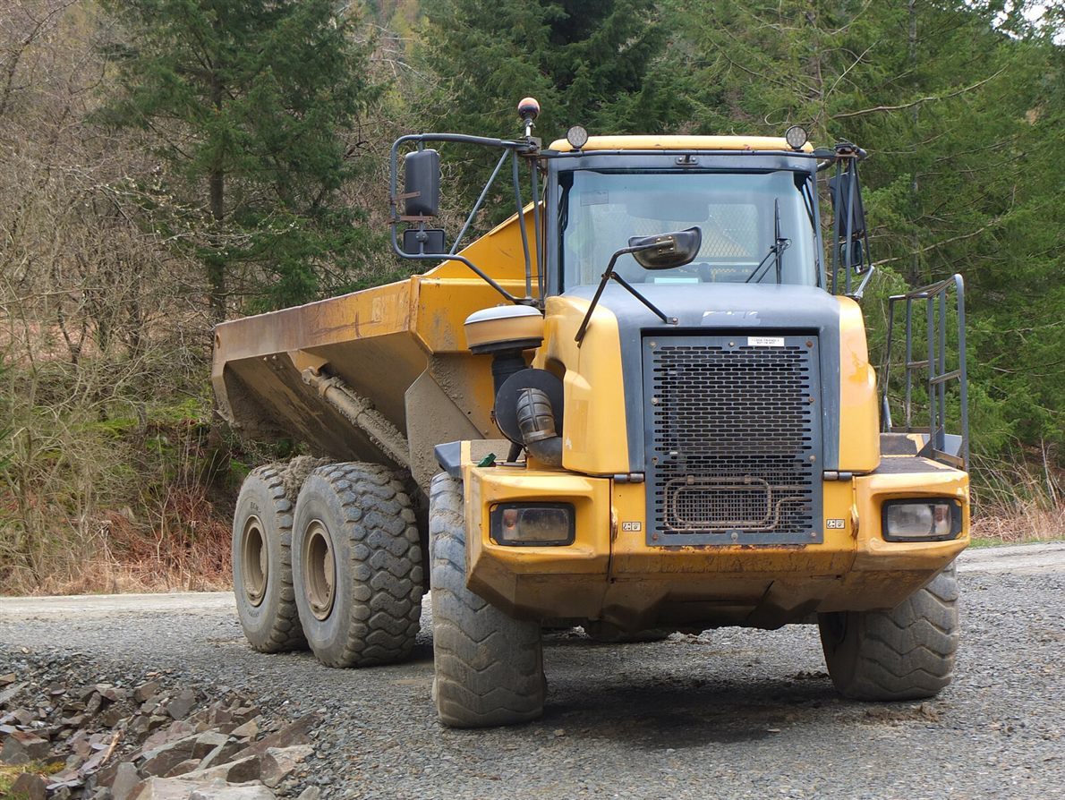 Articulated dump truck on a rough forest track