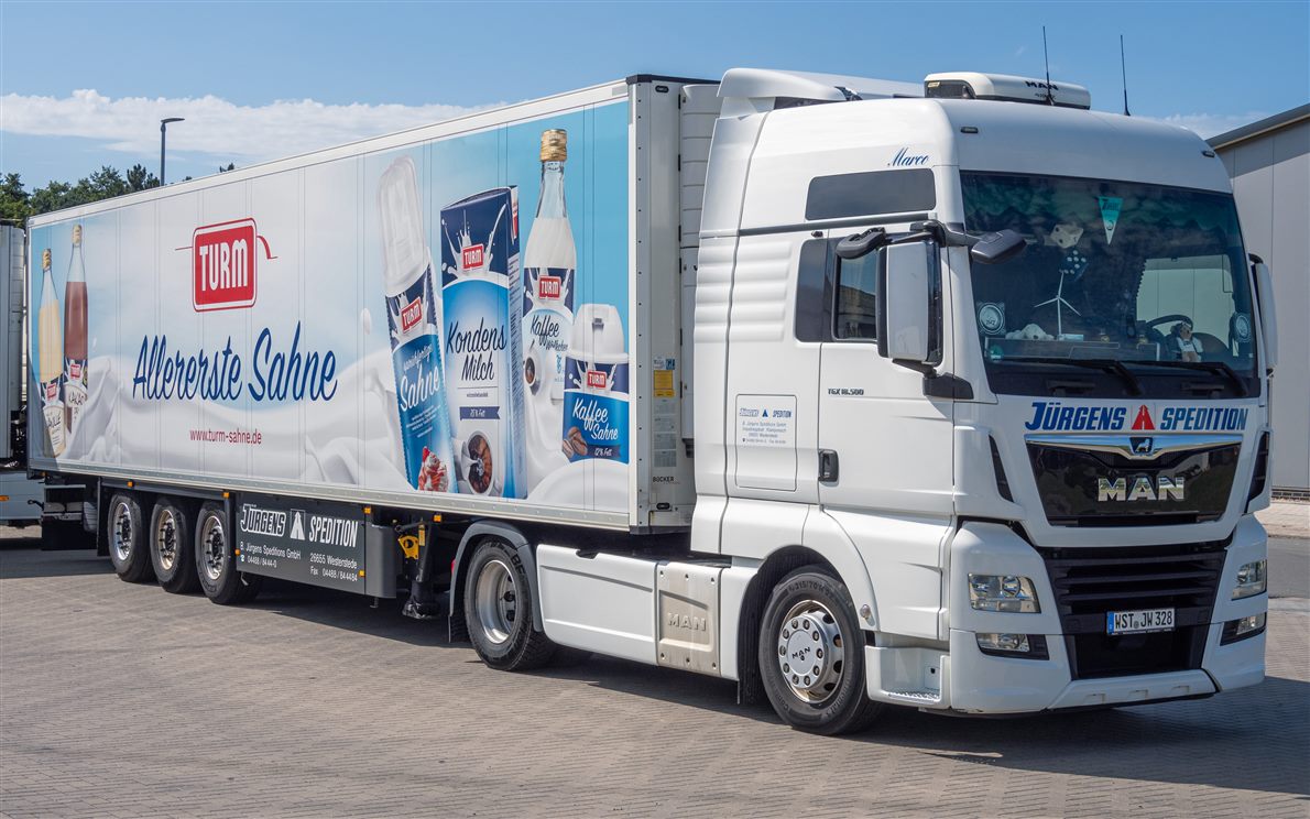 White MAN TGX articulated truck with a box trailer