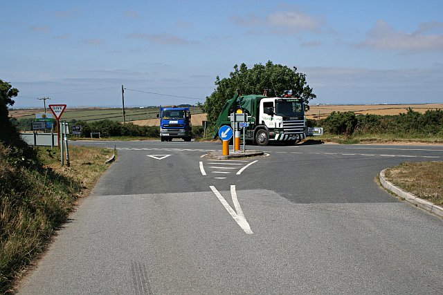 Two goods vehicles at a rural road junction