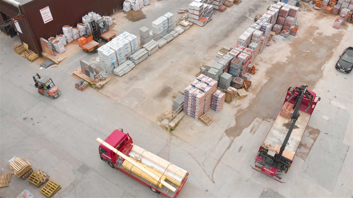 A true overhead aerial view of trucks in a yard