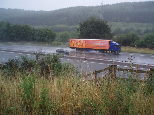 Goods vehicle throwing up spray on a wet motorway